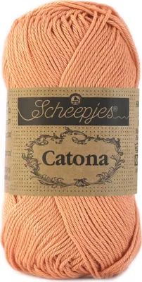 A ball of peach-colored yarn with a brown label.