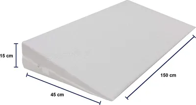 A white wedge pillow with dimensions indicated.