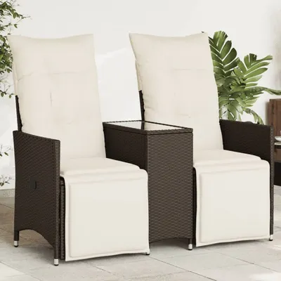 Two brown poly rattan garden chairs with cream cushions and a small table between them, placed on a patio.