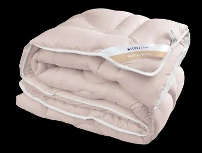 A folded pink duvet is presented against a black background.