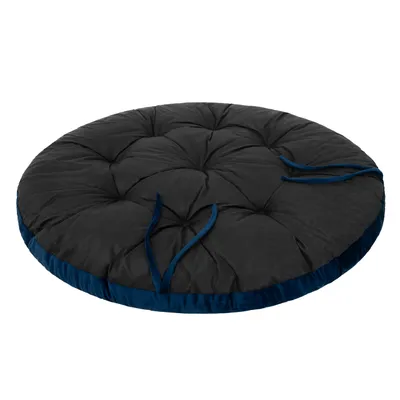 A round, tufted cushion with blue trim and ties, shown from a slightly elevated side angle against a white background.