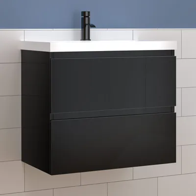 A modern black vanity unit with a white ceramic sink and a black faucet, mounted on a tiled wall.