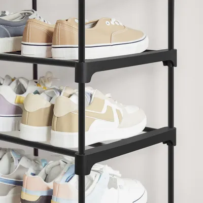 A close-up view of a multi-tiered shoe rack filled with various shoes.