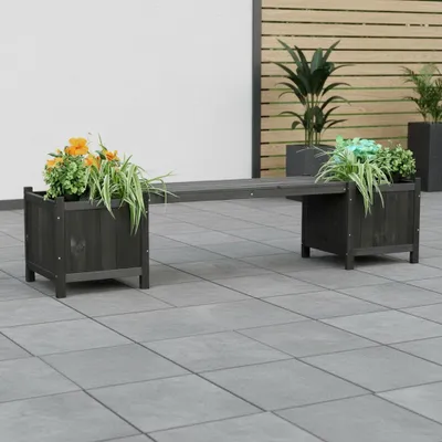 A dark gray wooden bench with two integrated planters, one on each side, filled with green and orange plants. The bench is placed on a gray tiled patio.