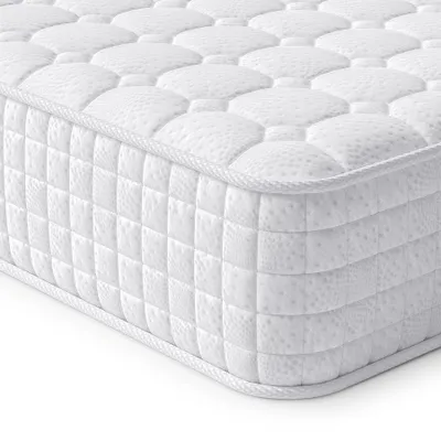 A close-up, angled view of a white mattress, showing its quilted surface and side texture.