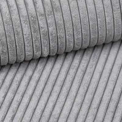 A close-up, detailed shot of grey corduroy fabric folded over itself, showing the texture and ridges.