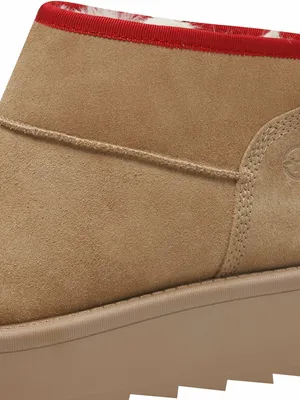 A close-up view of the top edge and side of a tan boot.