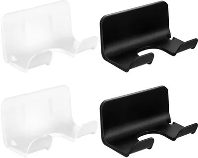 Image de Support mural pour sèche-cheveux Unyqoos®, lot de 4, à fixer sans percer. Comprend 2 supports noirs et 2 supports blancs, en plastique, de diamètre 5,2 cm, adaptés aux surfaces en carrelage et en marbre