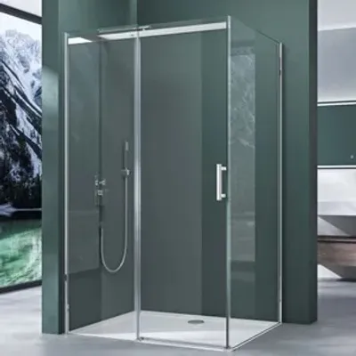 A modern shower cabin with a sliding door, set in a bathroom with dark green walls and a scenic mural on the left.