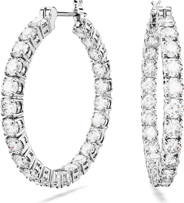 A pair of diamond hoop earrings on a white background.
