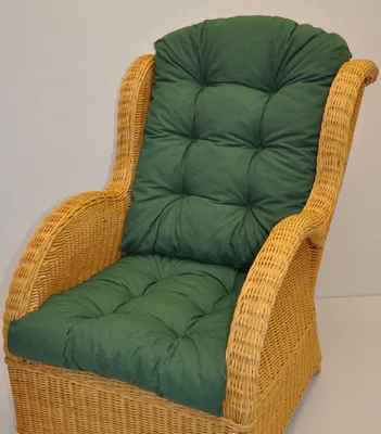 A close-up shot of a green cushion on a wicker chair.