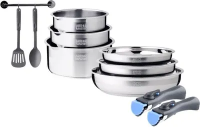 A set of stainless steel cookware with detachable handles and kitchen utensils on a rack.