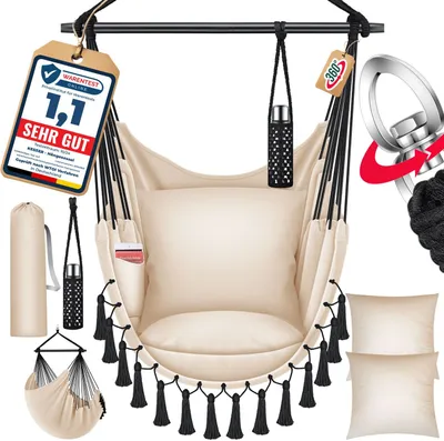 A beige hammock chair with black tassels, pillows, and accessories, displayed against a white background.