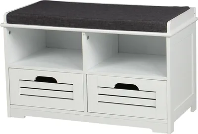 A white shoe bench with a dark gray cushion on top, featuring two open shelves and two slatted drawers below.