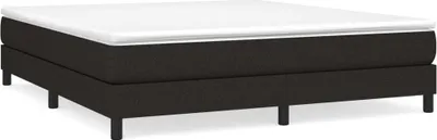 A black boxspring bed with a white mattress topper on a white background.