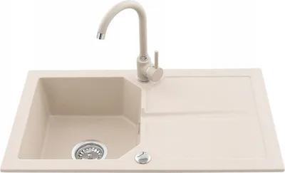 A beige kitchen sink with a faucet against a white background.