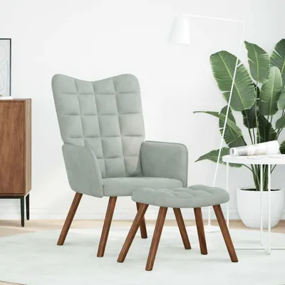 A living room setting with a chair and ottoman.