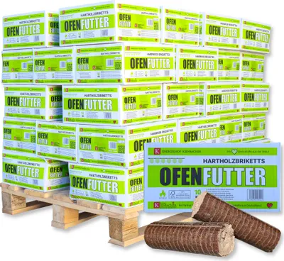 A large stack of cardboard boxes containing firewood briquettes, arranged on a wooden pallet. A few briquettes are shown in the foreground.