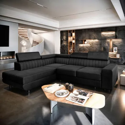 A modern living room with a large black sectional sofa and a unique coffee table.