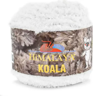 A ball of fluffy white yarn with a patterned label.