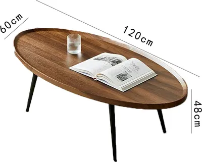 A wooden oval coffee table with a book and a glass of water on it, with dimensions indicated by text overlays.