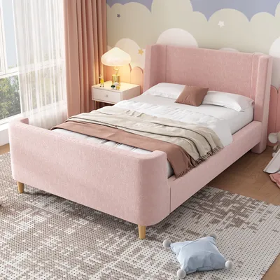 A pink upholstered bed in a child's bedroom with a patterned rug and curtains.