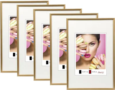A set of gold-colored picture frames with images of macarons and a woman's face visible through the matting.