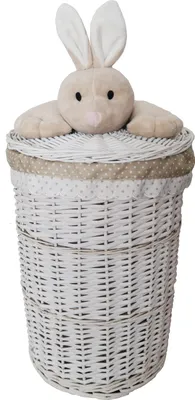 A white wicker laundry basket with a lid and a plush bunny toy on top.