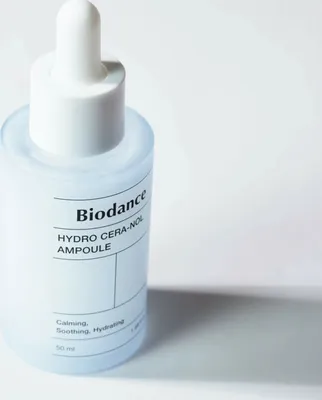 A close-up studio shot of a skincare ampoule bottle.