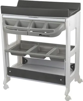A white changing table with gray storage compartments and a dark gray changing mat.