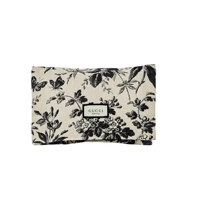 A flat lay of a pouch with a floral and butterfly print.