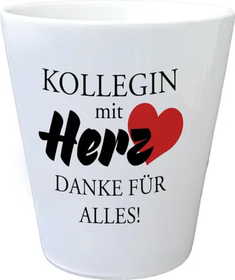 A white ceramic mug with text and a heart graphic.