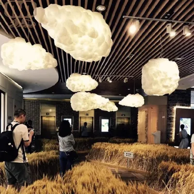 A room decorated with wheat stalks and cloud-shaped lamps.