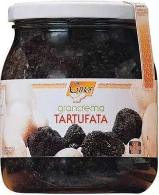 A jar of truffle paste with truffles and garlic shown on the label.