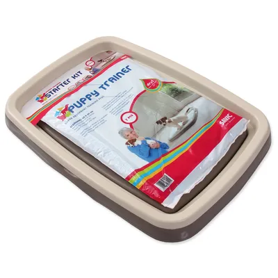 A puppy training kit is placed inside a beige and brown plastic tray.