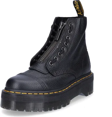 A black Dr. Martens platform boot with a zipper and laces.