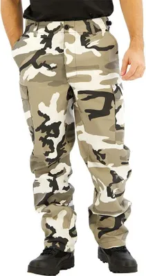 A person wearing camouflage cargo pants and black shoes.