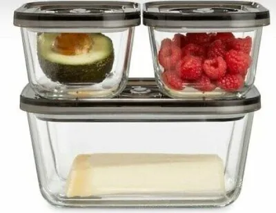 A set of three glass vacuum seal food storage containers, stacked, with food inside.