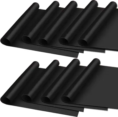Two rows of black grill mats rolled up.