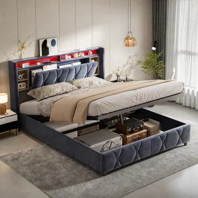 A bedroom setting with a bed that has storage underneath and a headboard with shelves and lighting.