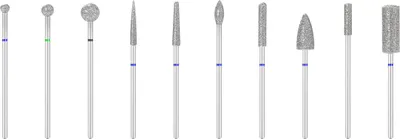A collection of diamond burrs for dental or engraving use, arranged in a line against a white background.