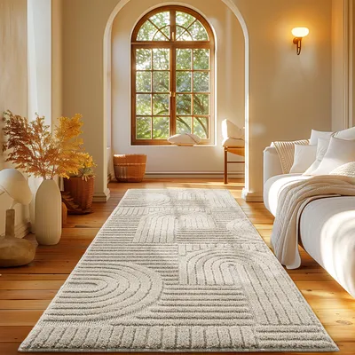 A living room scene with a rug in the foreground, a sofa on the right, and a large arched window in the background.