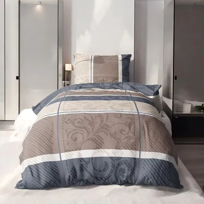 A bed with bedding set in a room.