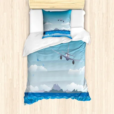 A duvet cover and pillow set with a cartoon airplane flying over a seascape.