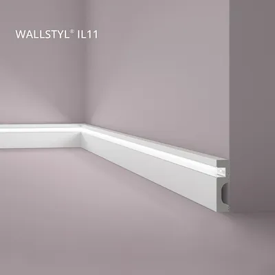 A corner of a room with a white baseboard featuring integrated LED lighting.