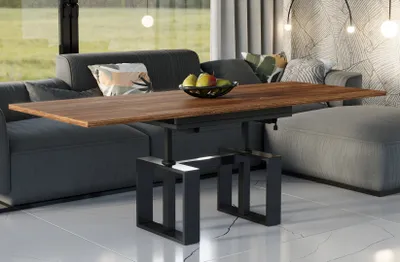 A modern living room with a sofa, coffee table, and ottoman.