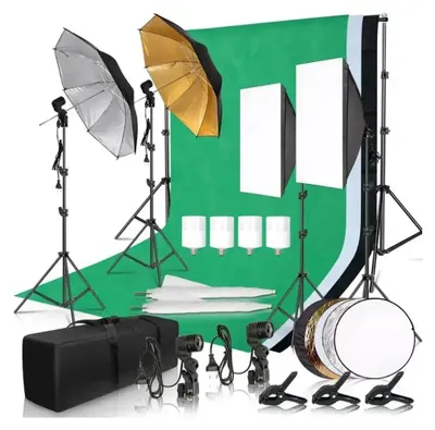 A photography lighting kit is arranged on a green backdrop.