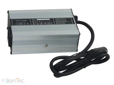 A silver battery charger with a black cable is shown against a white background.
