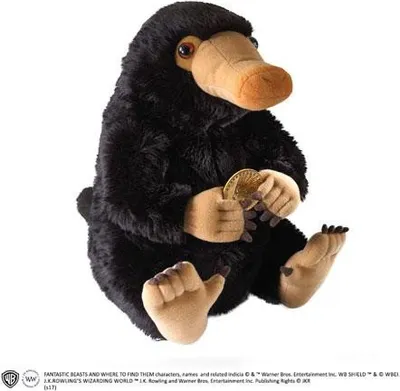 A plush toy Niffler from Fantastic Beasts is sitting and holding a gold coin.