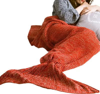 A person is wrapped in a red mermaid tail blanket.